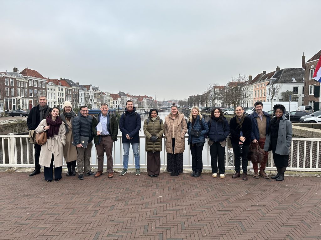 Professor Manisha Sinha, with colleagues, on a bridge over a river.